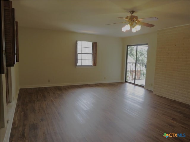 213 Tracy Ln, Victoria, TX 77904 - unfurnished room with healthy amount of natural light, a ceiling fan, wood finished floors, and brick wall