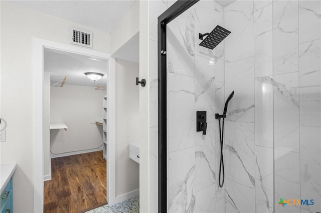 213 Tracy Ln, Victoria, TX 77904 - full bath with a marble finish shower, vanity, and wood finished floors