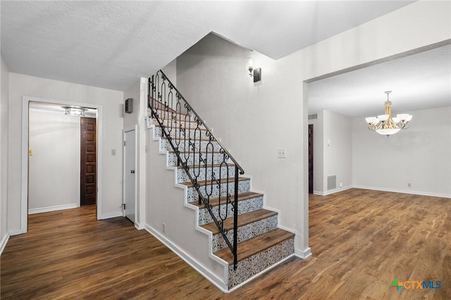 213 Tracy Ln, Victoria, TX 77904 - stairs featuring a chandelier and wood finished floors