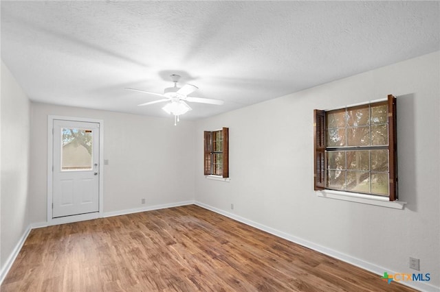 213 Tracy Ln, Victoria, TX 77904 - unfurnished room featuring wood finished floors, ceiling fan, and a textured ceiling