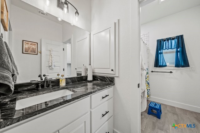 bathroom with vanity and wood-type flooring