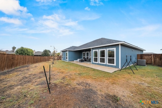 rear view of house featuring a yard, a patio, and cooling unit