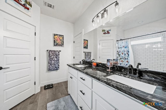 bathroom featuring hardwood / wood-style flooring, vanity, and a shower with shower curtain