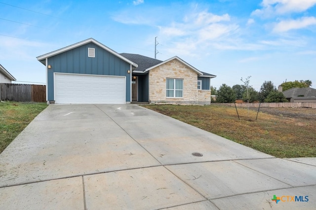 single story home with a front yard and a garage