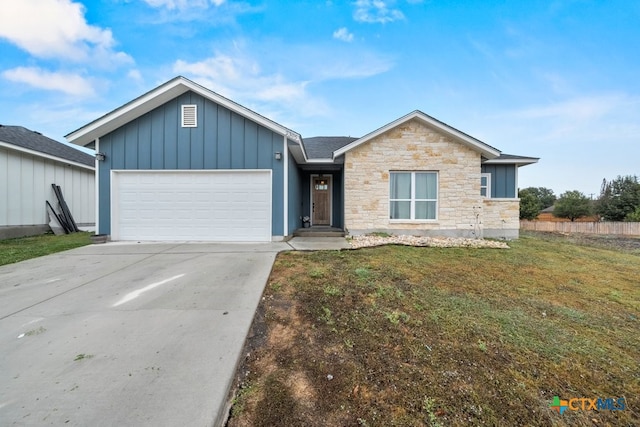 view of front of house featuring a garage and a front lawn