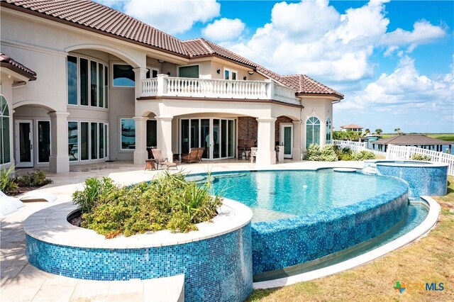 153 E Tuscany Way, Port Oconnor, TX 77979 - view of pool featuring a pool with connected hot tub, a patio, and fence