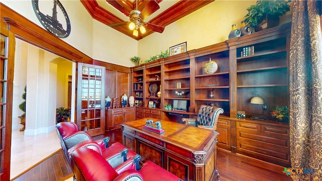 office with ceiling fan, a towering ceiling, dark hardwood / wood-style floors, and crown molding