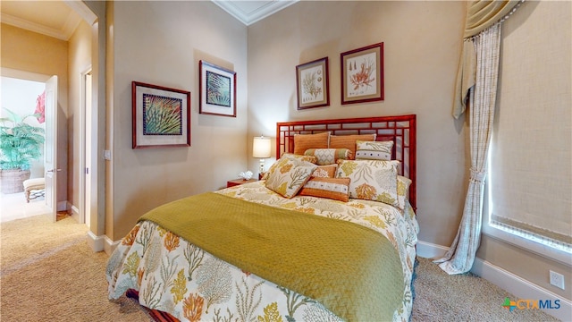 carpeted bedroom with ornamental molding and multiple windows