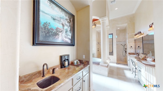 bathroom featuring vanity, tiled shower, crown molding, tile patterned floors, and ornate columns