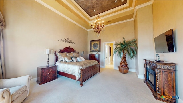 bedroom featuring light carpet, a tray ceiling, a towering ceiling, a chandelier, and crown molding