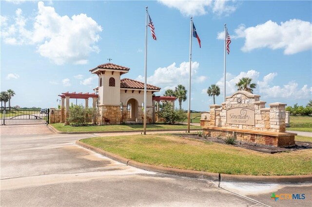 153 E Tuscany Way, Port Oconnor, TX 77979 - community / neighborhood sign featuring a gate and a yard