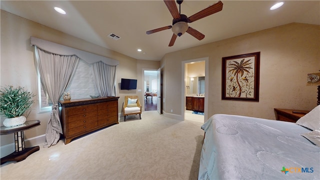 carpeted bedroom featuring connected bathroom, vaulted ceiling, and ceiling fan