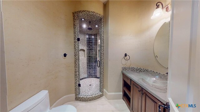 153 E Tuscany Way, Port Oconnor, TX 77979 - bathroom featuring toilet, vanity, and a stall shower
