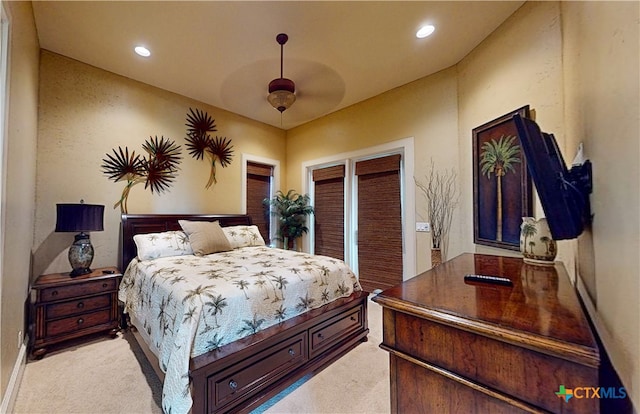 bedroom featuring ceiling fan and light carpet