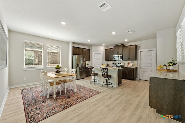 2917 Sage Ranch Dr, Leander, TX 78641 - dining area with light wood finished floors and recessed lighting