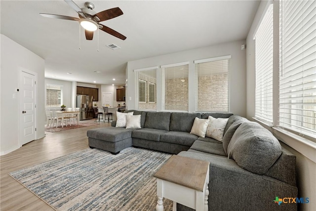 2917 Sage Ranch Dr, Leander, TX 78641 - living area featuring light wood-style flooring, a ceiling fan, healthy amount of natural light, and recessed lighting