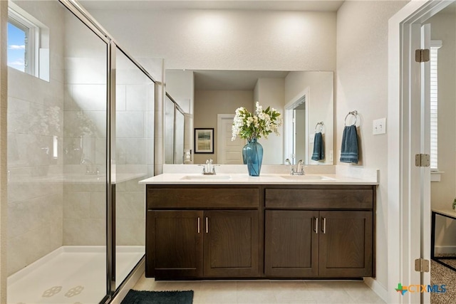 2917 Sage Ranch Dr, Leander, TX 78641 - bathroom featuring a shower stall, double vanity, and tile patterned flooring
