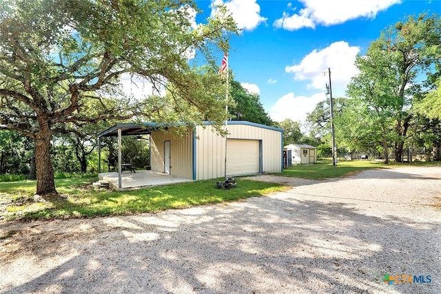 661 Abels Way, Canyon Lake, TX 78133 - garage featuring gravel driveway and a detached garage