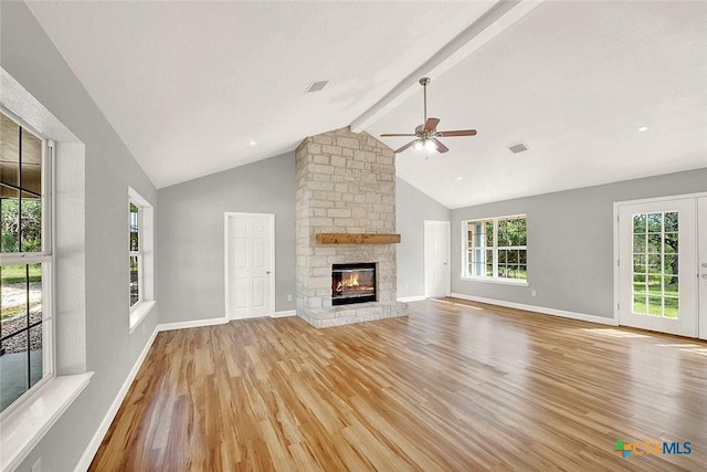 661 Abels Way, Canyon Lake, TX 78133 - unfurnished living room featuring light wood-style flooring, a ceiling fan, a stone fireplace, beamed ceiling, and baseboards