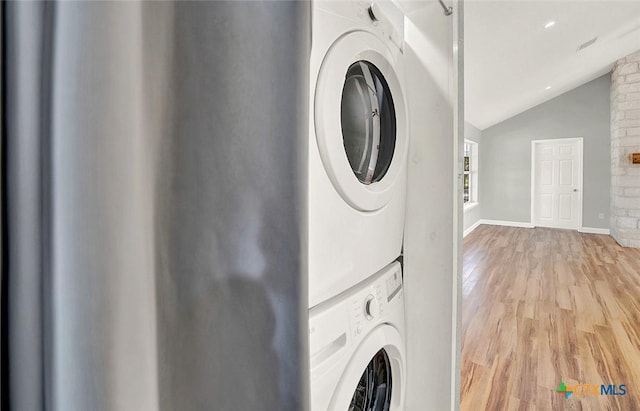 661 Abels Way, Canyon Lake, TX 78133 - laundry room featuring stacked washer and clothes dryer, light wood finished floors, and baseboards