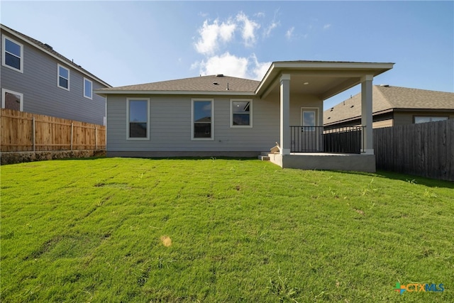 rear view of house with a lawn