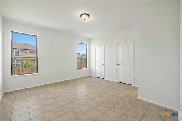 tiled spare room with plenty of natural light