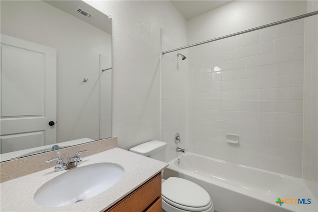 full bathroom featuring vanity, toilet, and tiled shower / bath combo