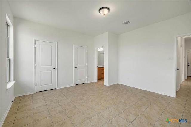 unfurnished bedroom featuring ensuite bathroom