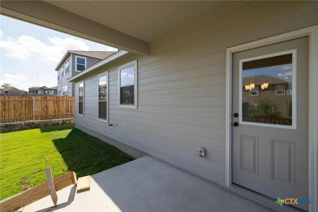 doorway to property with a lawn