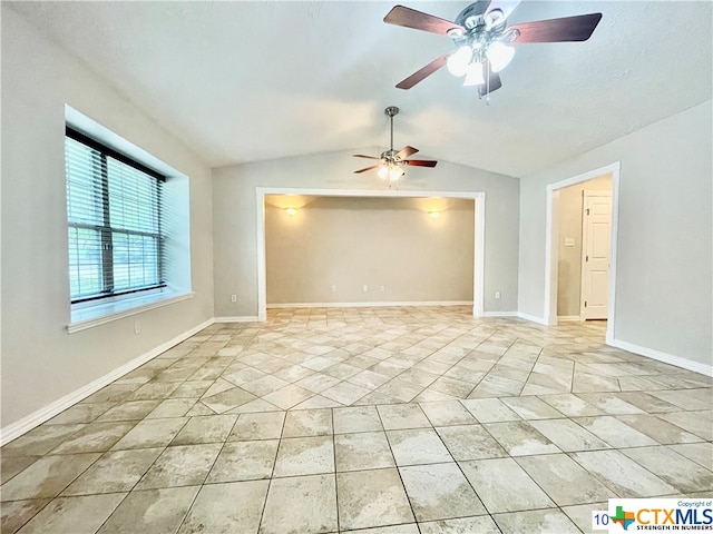 spare room with ceiling fan and lofted ceiling