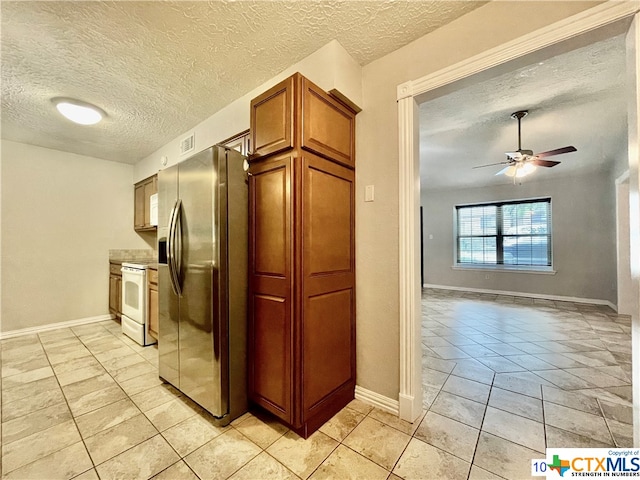 kitchen featuring stainless steel refrigerator with ice dispenser, a textured ceiling, light tile patterned floors, ceiling fan, and white electric range