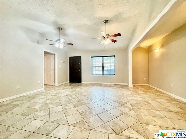 unfurnished room with a textured ceiling and ceiling fan