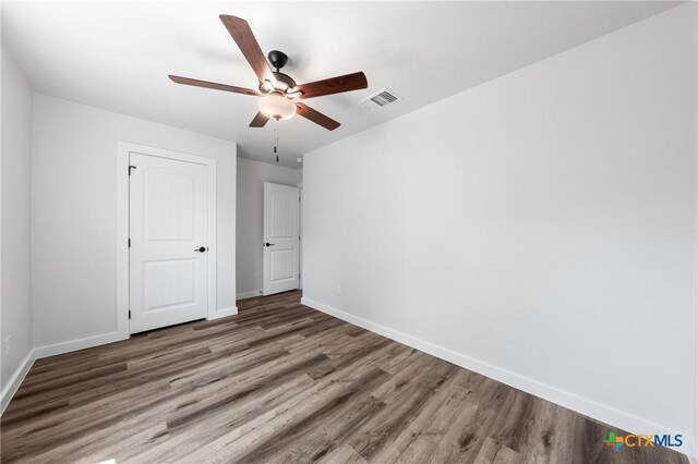 616 S 24th St, Temple, TX 76501 - unfurnished bedroom featuring wood finished floors, baseboards, and a ceiling fan