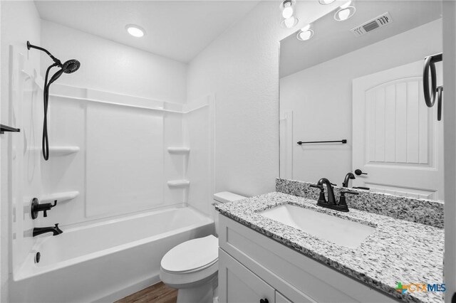 616 S 24th St, Temple, TX 76501 - bathroom featuring toilet, wood finished floors, vanity, and tub / shower combination