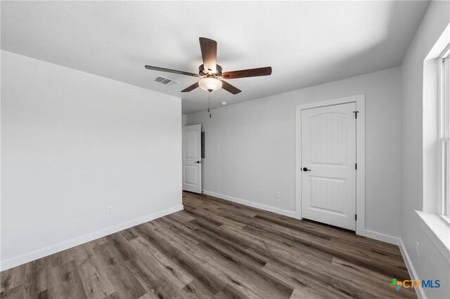 616 S 24th St, Temple, TX 76501 - spare room with dark wood finished floors, a ceiling fan, and baseboards