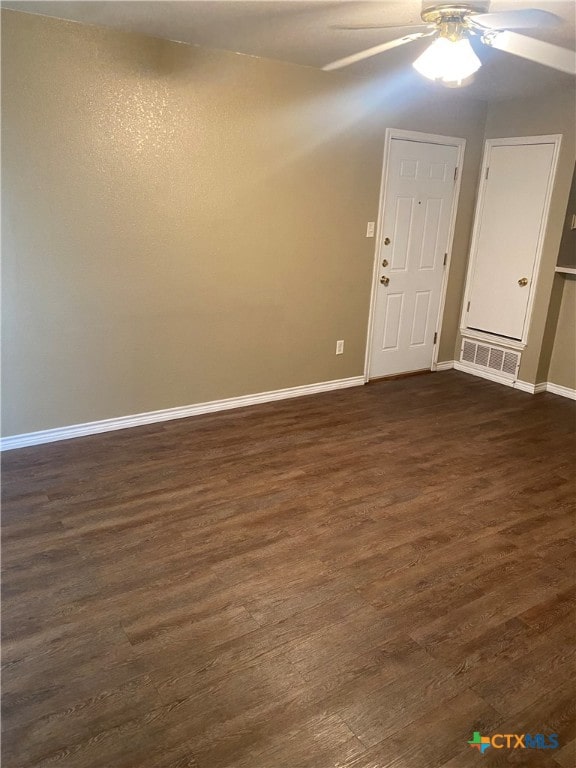 interior space with ceiling fan and dark hardwood / wood-style floors