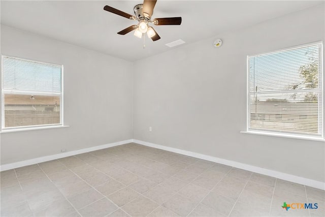 spare room featuring ceiling fan and light tile patterned floors