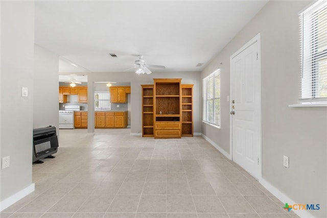 unfurnished living room with ceiling fan and light tile patterned floors