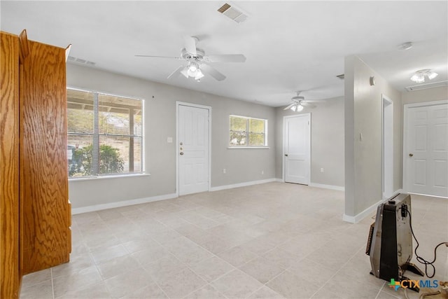 unfurnished living room featuring ceiling fan