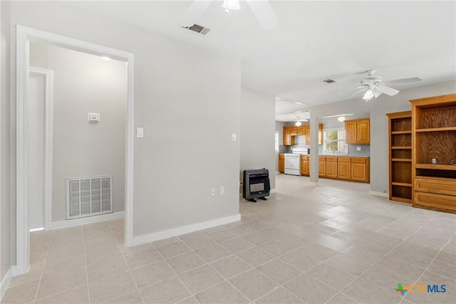 unfurnished living room featuring ceiling fan and light tile patterned floors