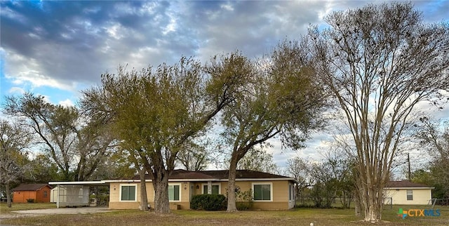 ranch-style house with a front yard and a carport