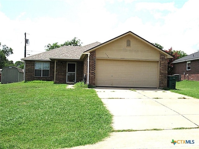 1104 N Blair St, Belton, TX 76513 - single story home with brick siding, concrete driveway, a garage, a front lawn, and a shed