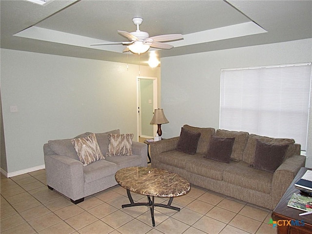 1104 N Blair St, Belton, TX 76513 - living area with light tile patterned flooring, a ceiling fan, and a raised ceiling