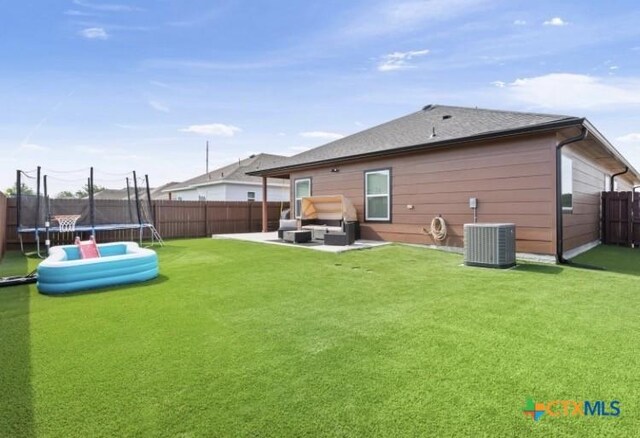 1606 Fiddle Wood Way, Temple, TX 76502 - back of house featuring a trampoline, an outdoor hangout area, a fenced backyard, and a patio