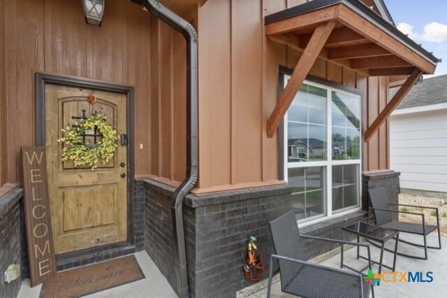 1606 Fiddle Wood Way, Temple, TX 76502 - view of exterior entry with covered porch and board and batten siding