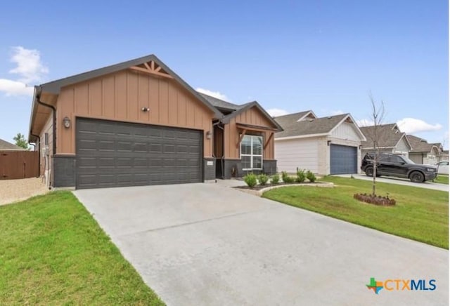 1606 Fiddle Wood Way, Temple, TX 76502 - view of front facade with board and batten siding, a garage, a front yard, and concrete driveway
