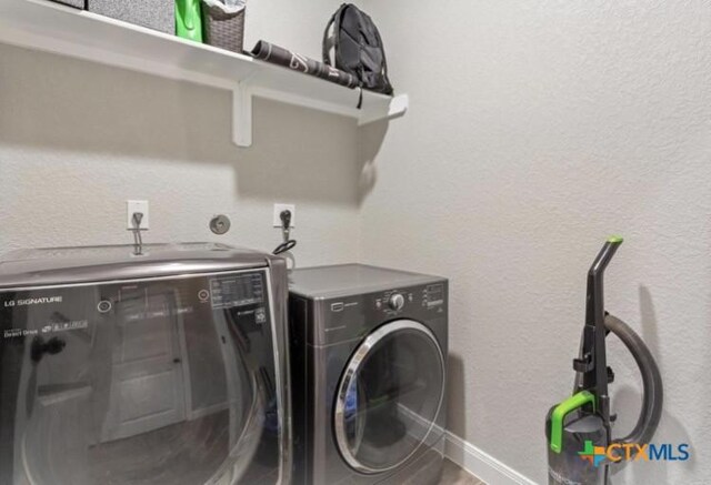 1606 Fiddle Wood Way, Temple, TX 76502 - washroom with independent washer and dryer and a textured wall