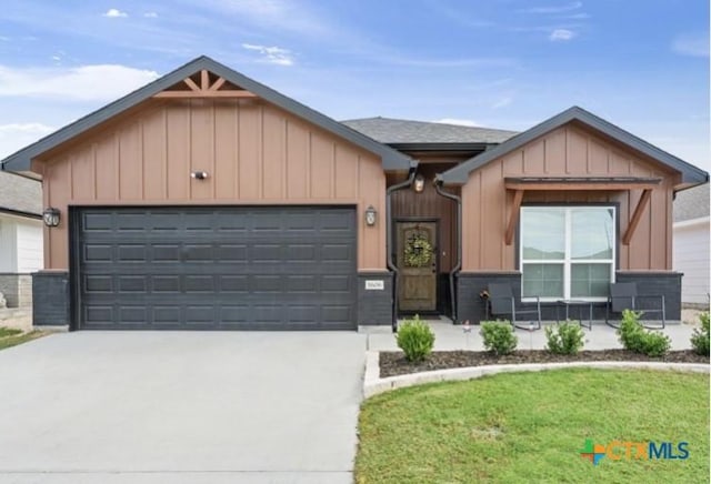 1606 Fiddle Wood Way, Temple, TX 76502 - ranch-style house featuring board and batten siding, concrete driveway, a garage, and a front yard