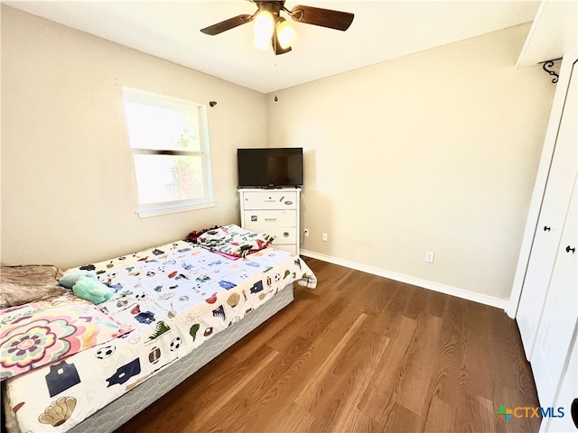 bedroom featuring ceiling fan, wood-type flooring, and a closet