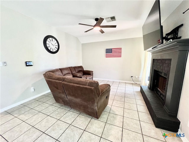 living room with a fireplace, light tile patterned flooring, ceiling fan, and vaulted ceiling